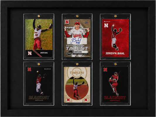 Framed collection of sports trading cards featuring athletes with Nebraska branding.